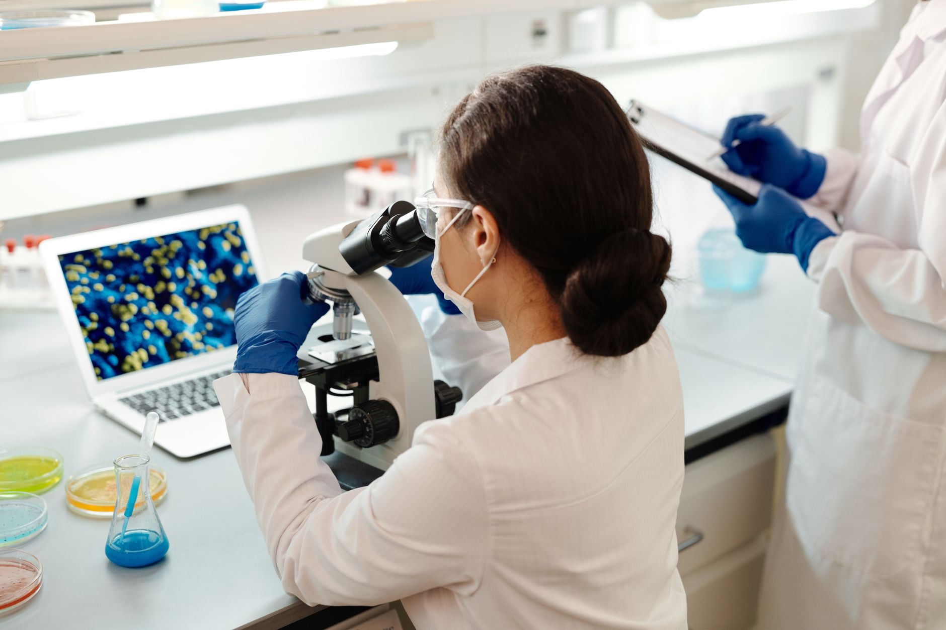 A researcher at a microscope
